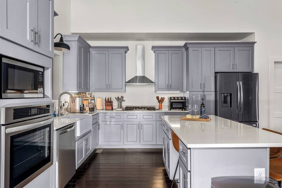 Fully equipped chef's kitchen with granite counter tops, all stainless steel appliances, and a gas range. 