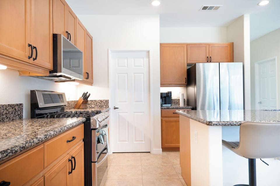 Fully stocked Kitchen with stainless steel appliances.