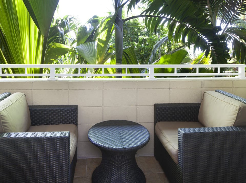 Breathe in tropical greenery while lounging with coffee outdoors.