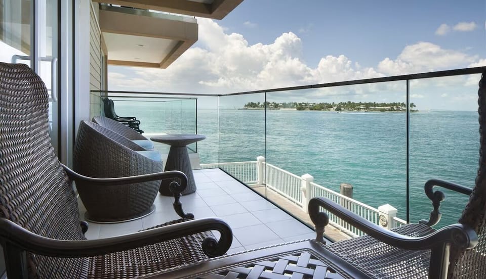 Sip morning coffee on the balcony above sparkling water.