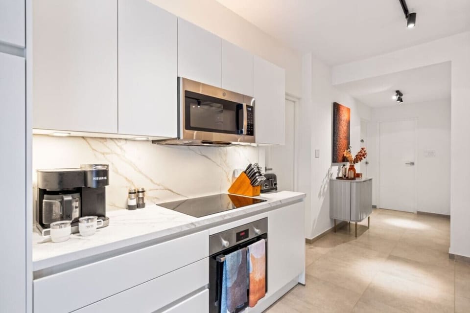 Get ready to whip up culinary magic in this sleek kitchen! Modern design and top-notch appliances make cooking a thrill!