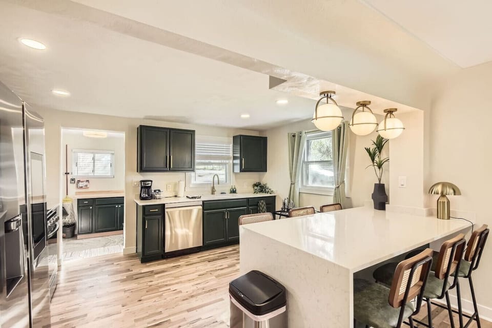 Gather in the open concept, fully stocked kitchen with spacious bar seating for 6