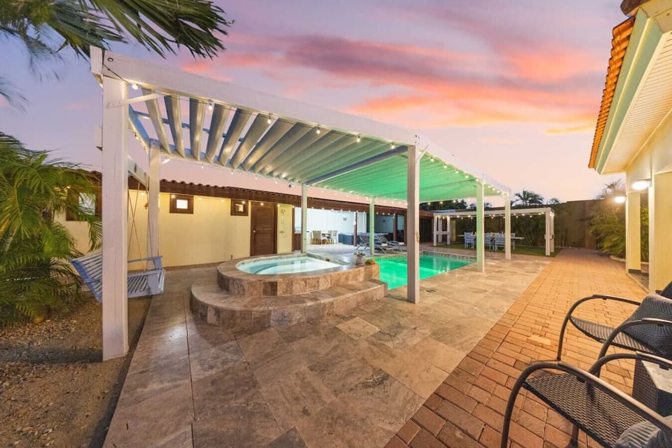 Soak in the bubbling hot tub with a sunset view and a cool drink in hand.