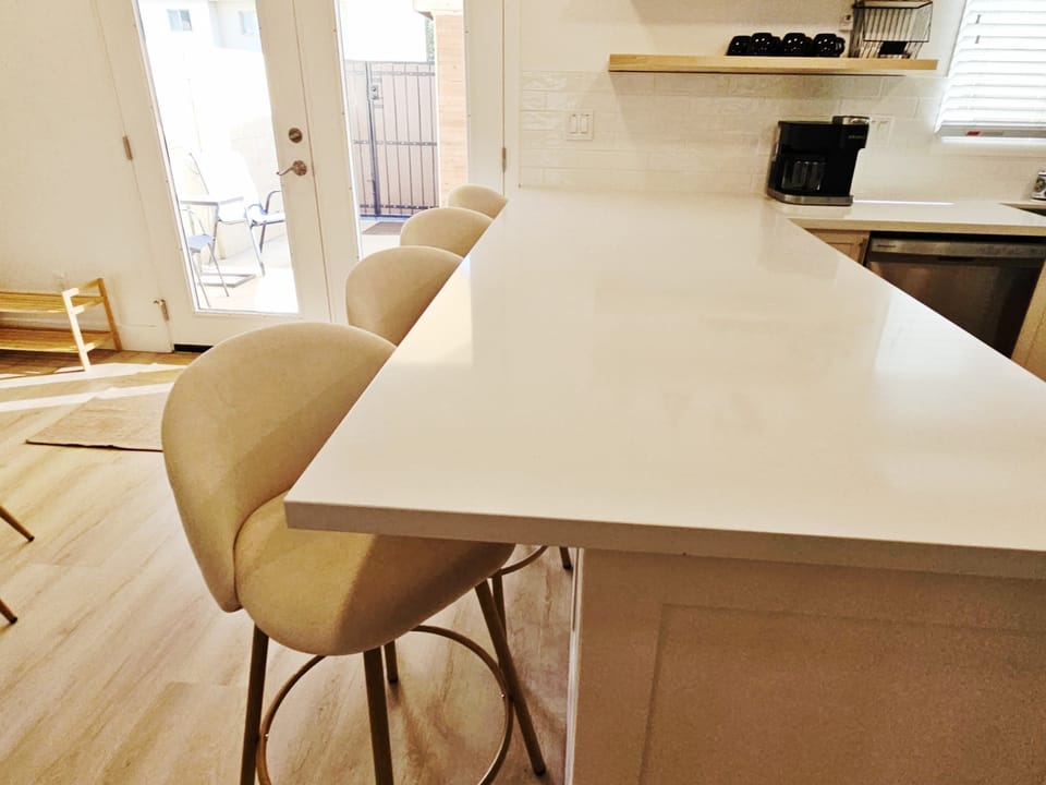 The airy, open kitchen offers ample space & every home comfort