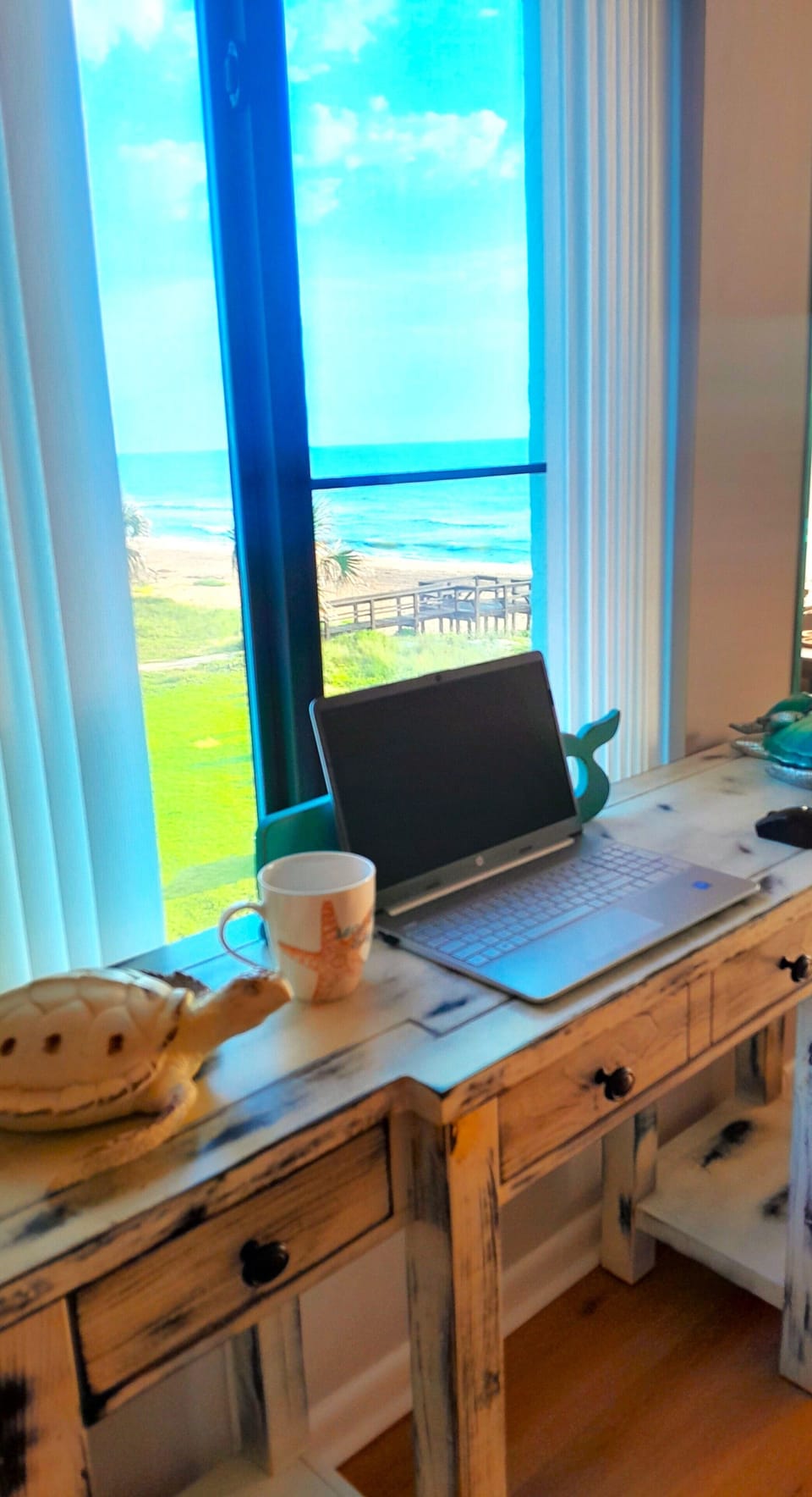 Work desk infront of side living room window. Distracting Ocean Views : )