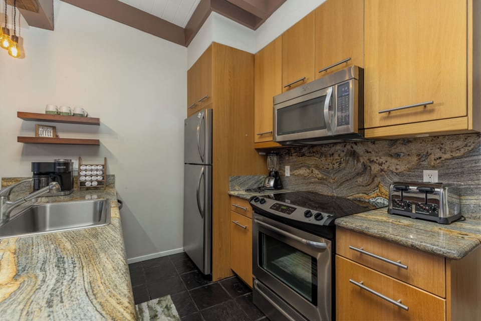 microwave, dishwasher, oven and stove top plus a fully stocked kitchen
