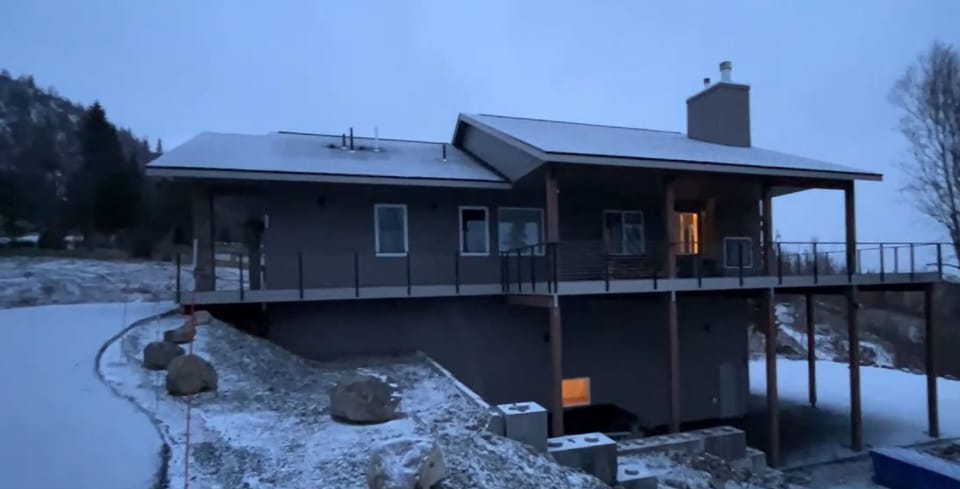 Decks galore.  Side deck is covered with an outdoor fireplace.
