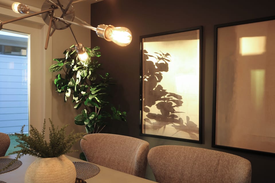 The dining room features modern design with a table that comfortably seats six.