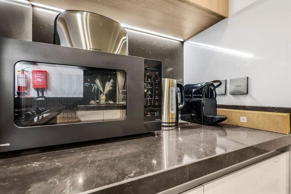 Modern Kitchen: Sleek appliances and stylish decor for culinary adventures await!