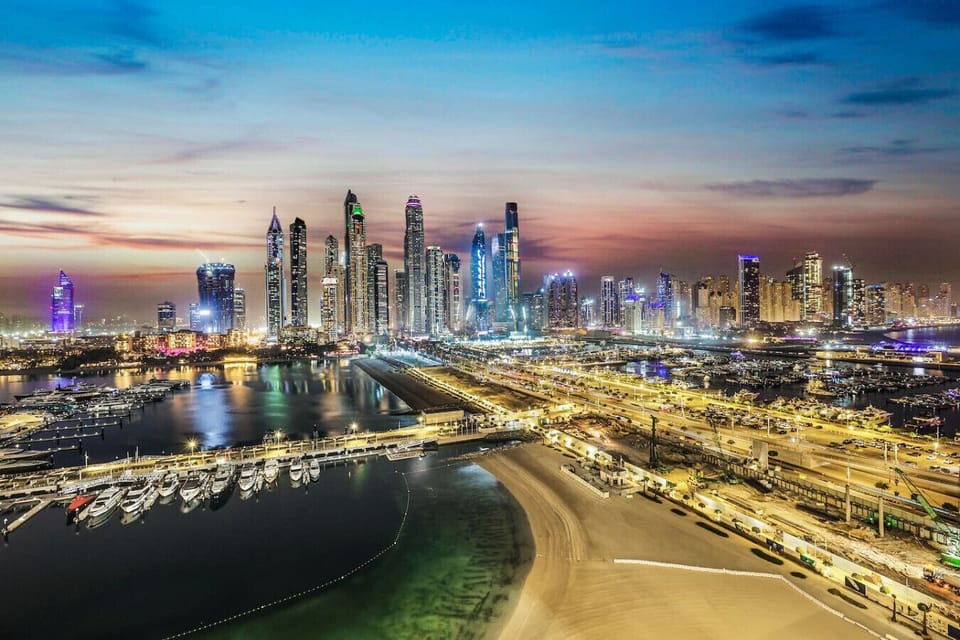 Skyline Vista: Immerse in stunning views of Dubai`s illuminated skyline and marina.