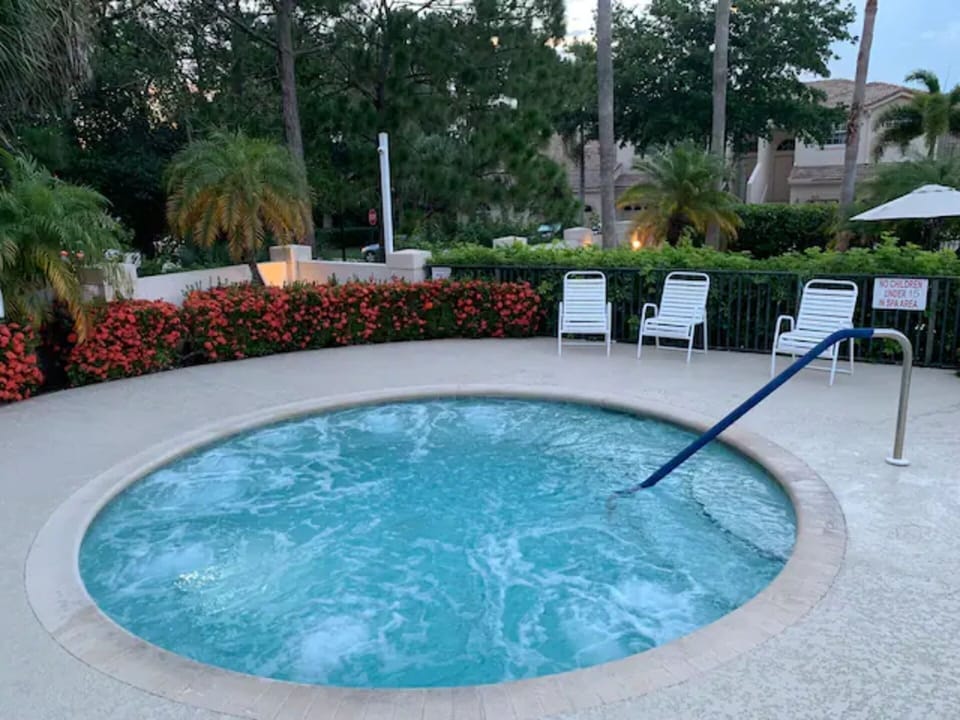 Relaxing community spa area surrounded by lush landscaping, perfect for unwinding.