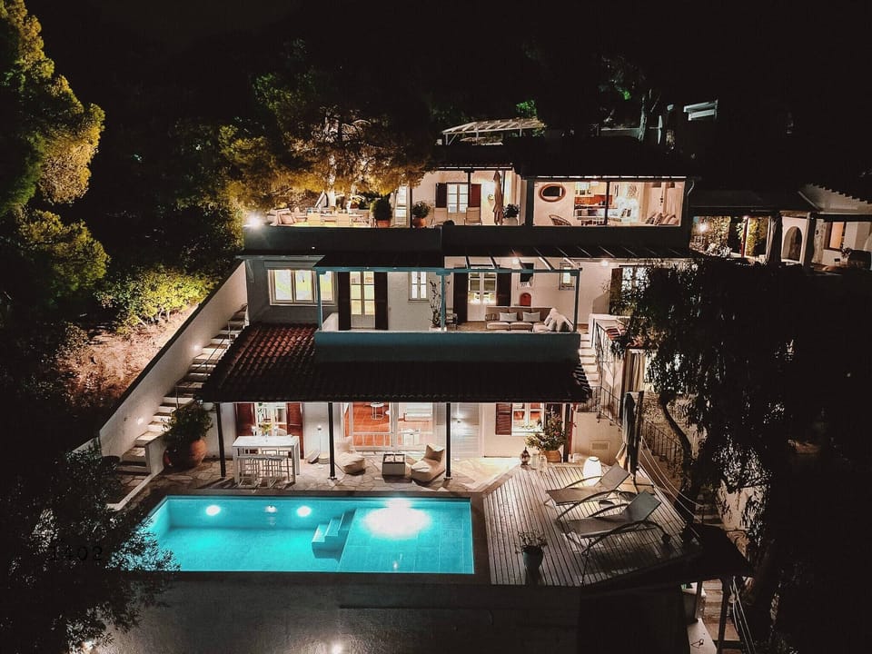 The villa in the evening, beautifully lit, atmospheric, and inviting to spend warm summer evenings on the terrace.