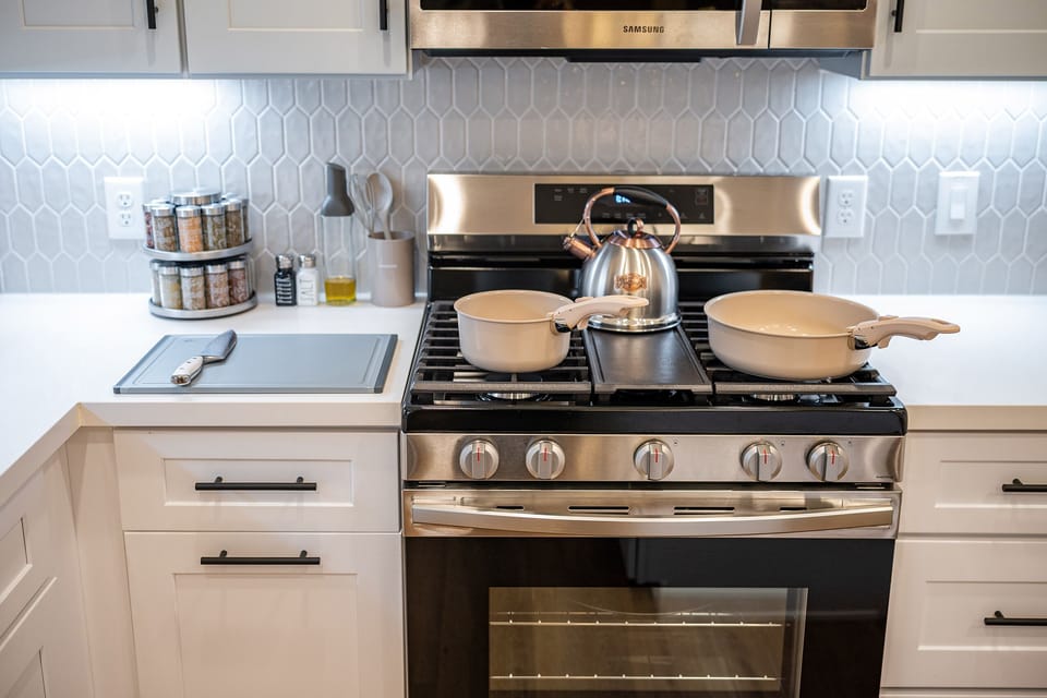 Fully stocked kitchen with modern gas range.