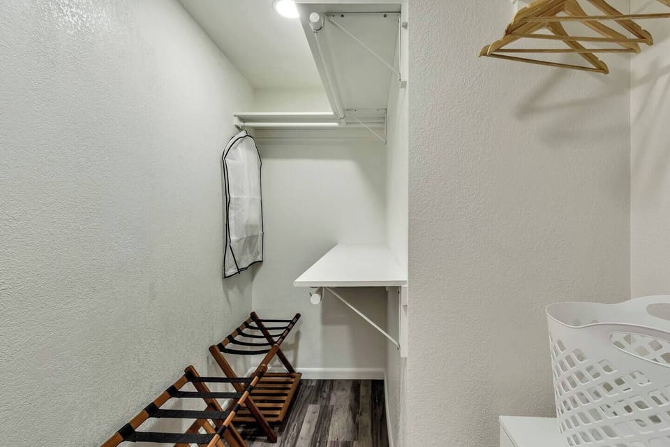 Master closet with suitcase storage.
