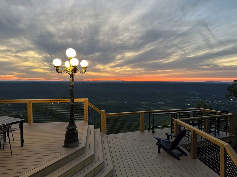 The Deck includes a dining table and chairs, bar table and chairs, & adirondacks