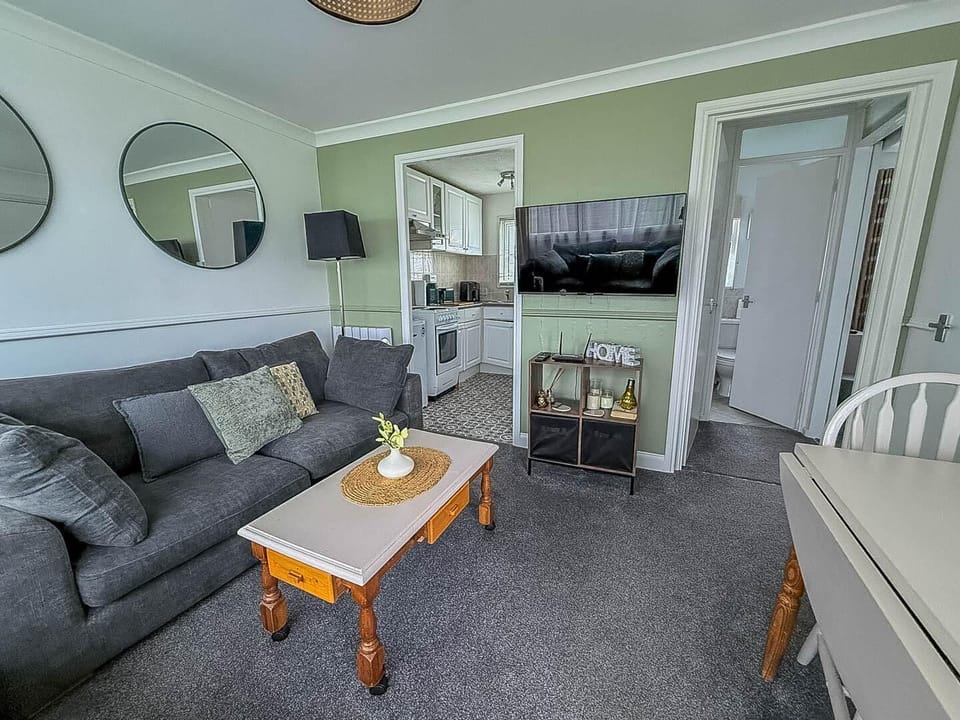 Step inside this chalet and discover a wonderfully spacious and welcoming open-plan living room, thoughtfully designed to bring everyone together, including your furry friend!
