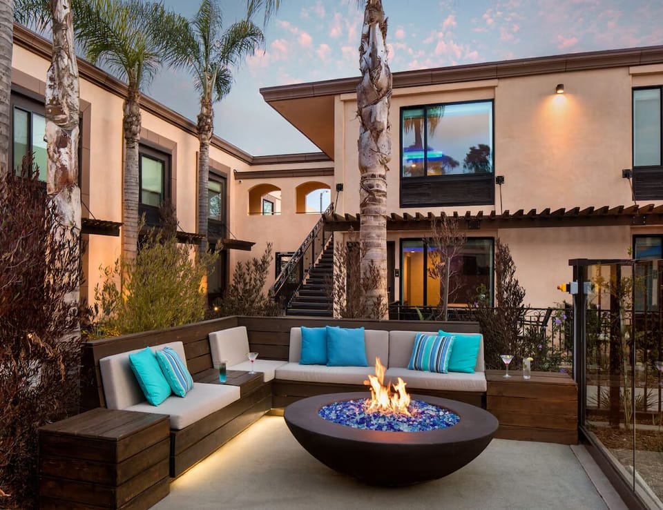 Gather by the glowing fire pit for cozy evening cocktails.