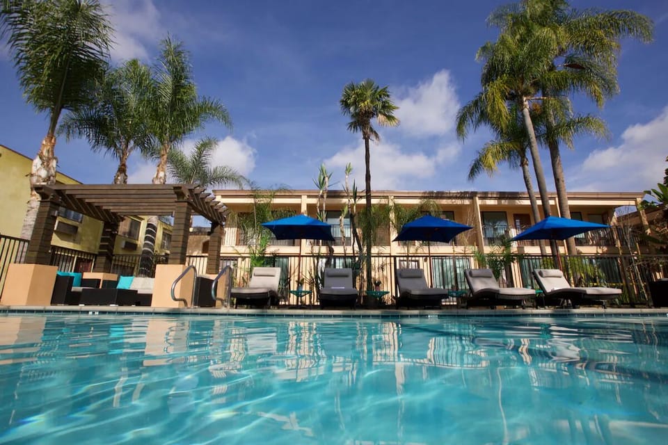 Stretch out on shaded loungers steps from cool water.
