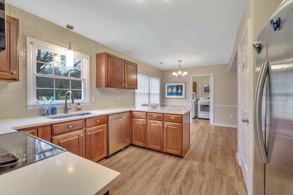Stainless steel appliances and view of patio and back yard