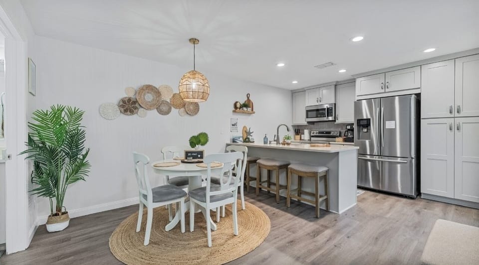 Dining and fully stocked kitchen with cleaning supplies, pots/pans & coffee/tea.
