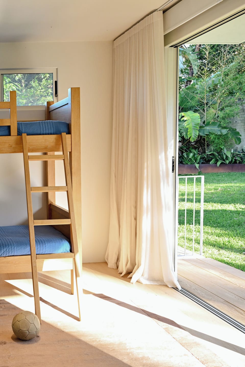 Bedroom 3 with bunks and sliding door access to large backyard