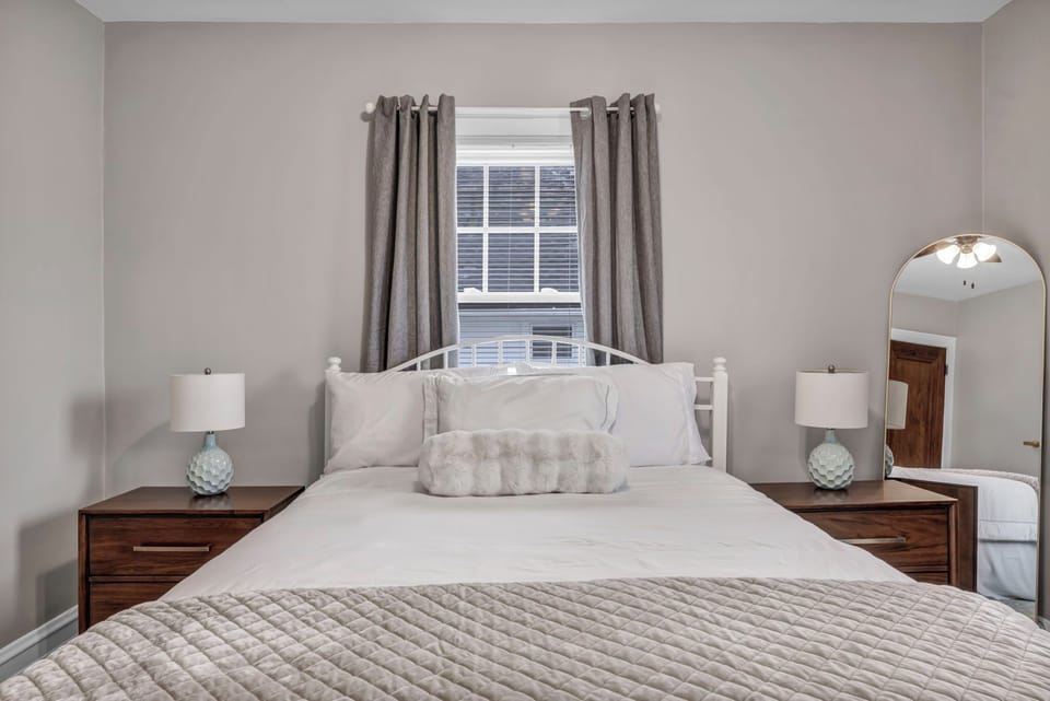 Queen hotel-quality bed with blackout curtains & USB charging nightstands