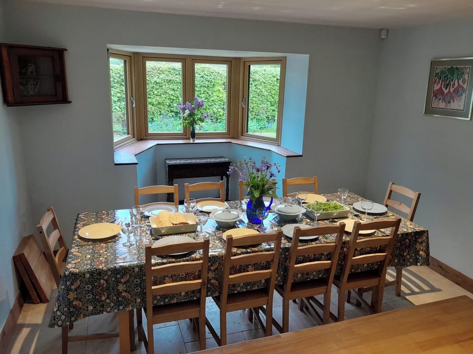 Open plan dining area adjacent to the kitchen with large table and chairs for 10 people