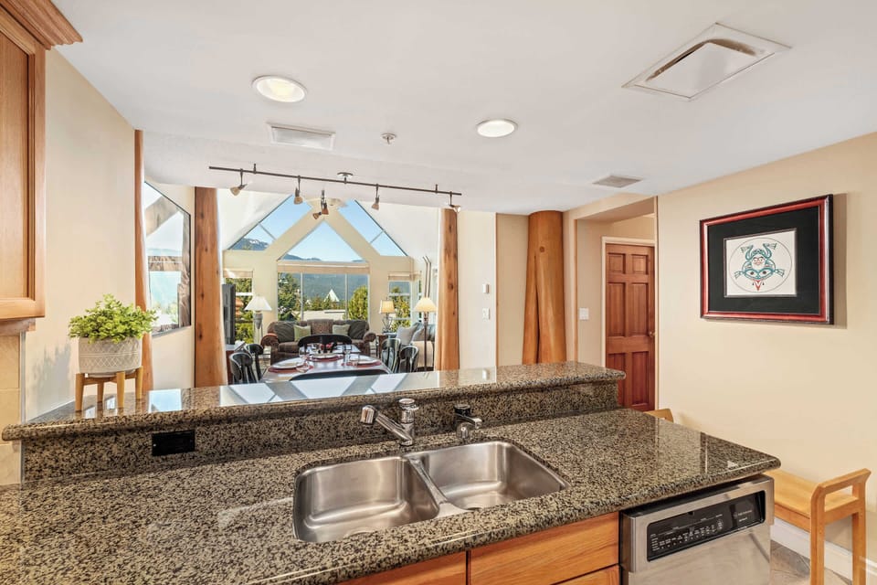 - Modern kitchen with granite countertops and stainless-steel finishes  
- Overlooks open-concept living with panoramic mountain window views  
- Perfect setup for cooking, gathering, and relaxing after outdoor fun  
