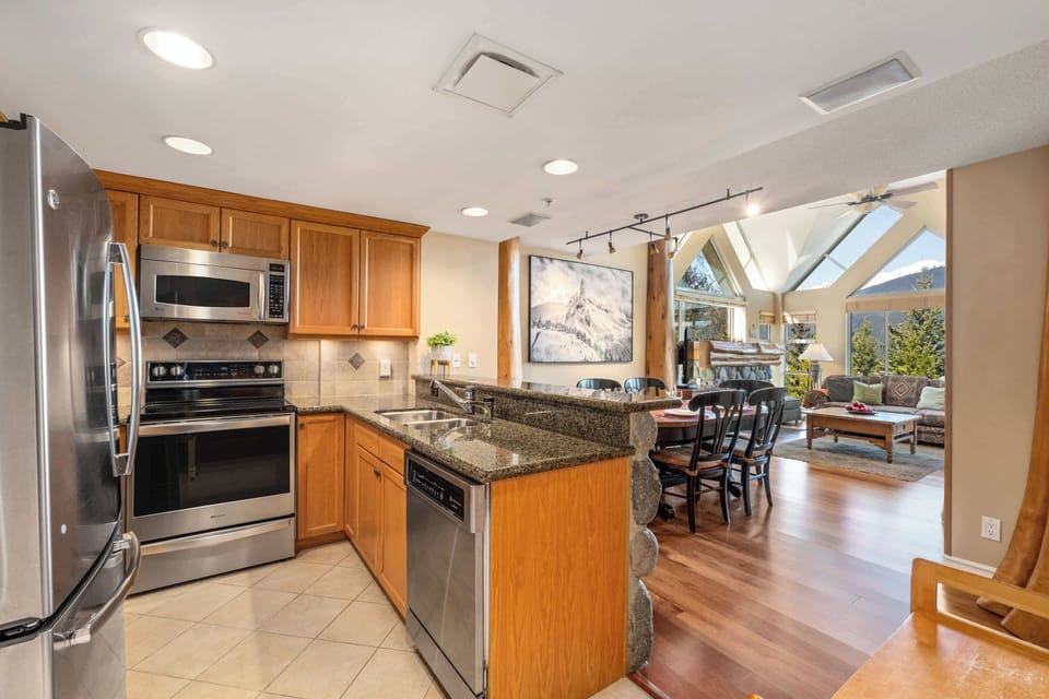 - Fully equipped kitchen with granite counters and sleek stainless appliances  
- Open layout connects to living and dining area filled with natural sunlight  
- Perfect for family stays and friends who enjoy relaxed home-style cooking  
