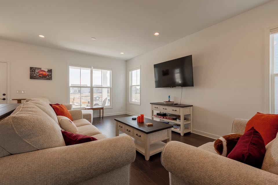 Entertainment-ready setup with board games, large screen, and comfy seating.
