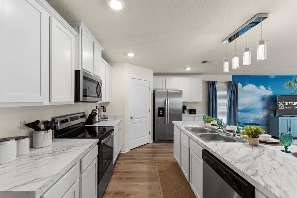 Kitchen: Modern appliances meet coastal charm. All the tools you need to feel at home.