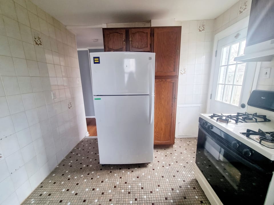 Step into a well-appointed kitchen designed for convenience. It includes a full-sized refrigerator, range, and plenty of counter space for meal prep. You'll find generous storage in the cabinetry, making it easy to keep things organized.
