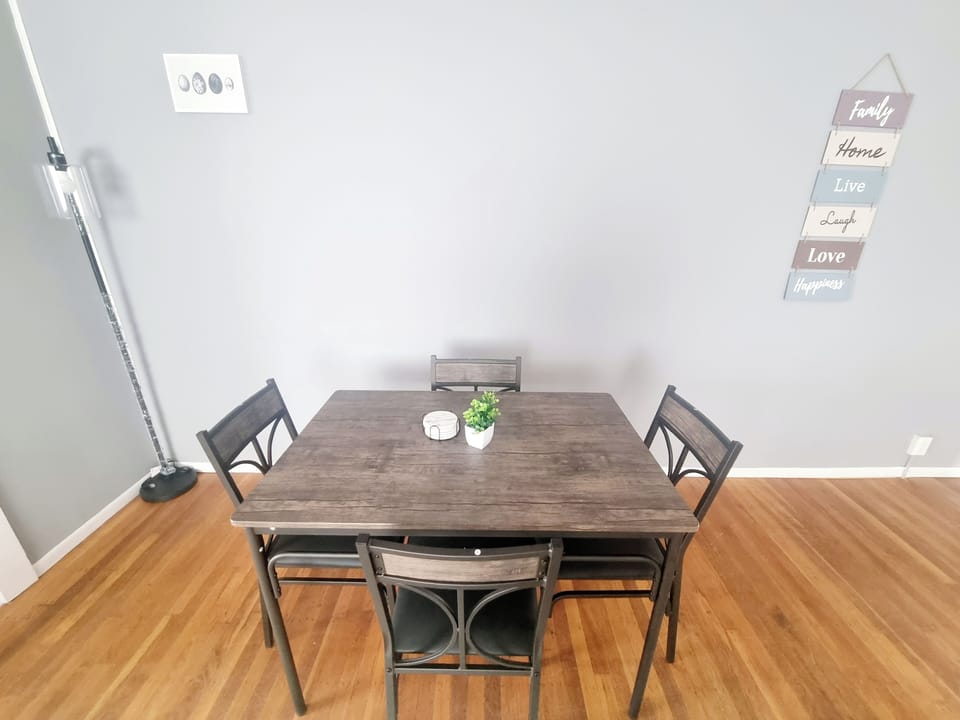 The living room comes furnished with essential pieces, including a comfortable sofa, a coffee table, TV stand, and dining table, providing immediate comfort upon move-in.
