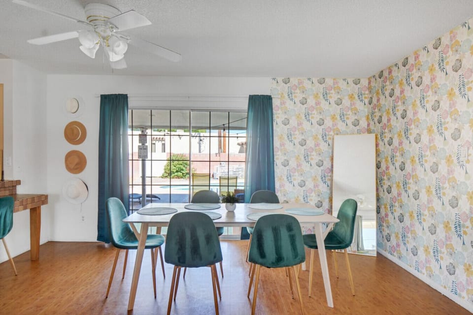 The dining area exudes a cheerful and inviting atmosphere with a touch of vintage charm. It`s a space that feels both cozy and spacious, perfect for enjoying meals and spending time with loved ones.