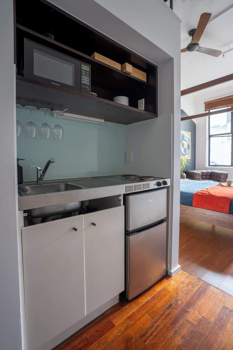 Kitchen with microwave, fridge and freezer, stove, sink, pants and pots, coffee and tee for your use  