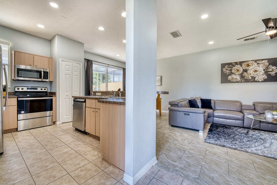 Open kitchen and living area with modern appliances and comfortable seating.