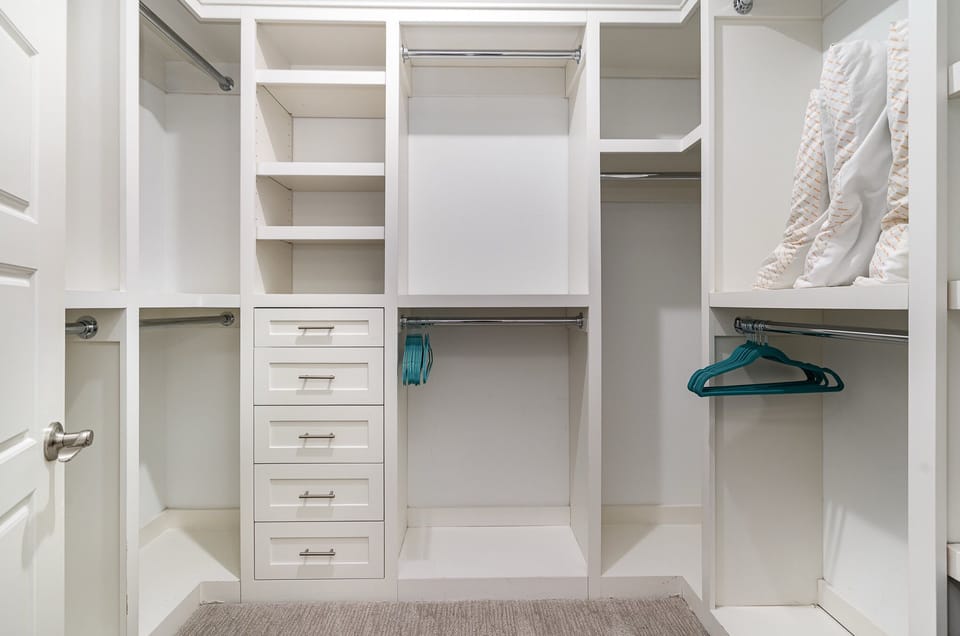 Unit 1: Primary Bedroom featuring a King bed with Smart TV, walk-in closet, and en-suite bathroom.