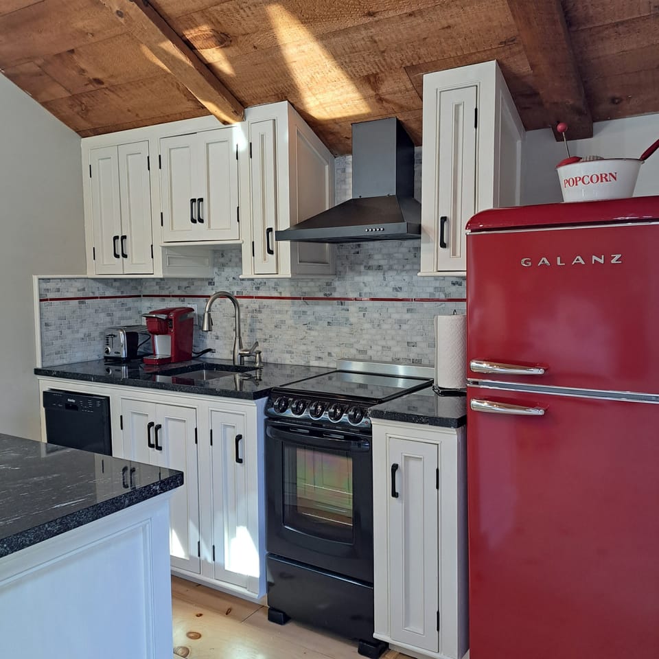 Fully stocked kitchen with refrigerator, stove, oven, microwave & dishwasher.