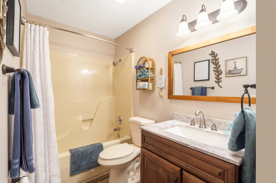 Wash up in the shared full bath, offering a single vanity & shower/tub combo