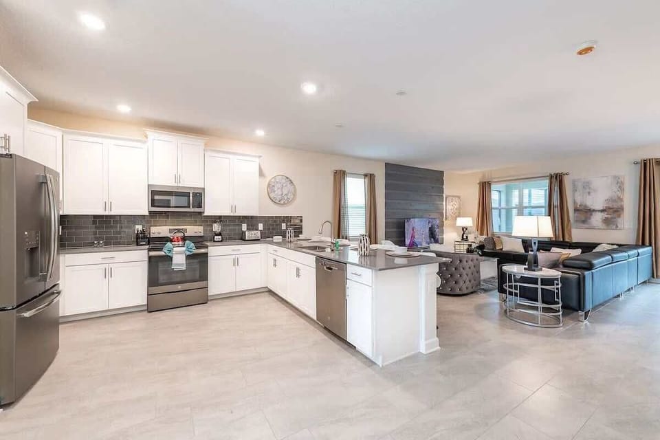 Spacious open kitchen and living area with sleek design and plenty of seating!