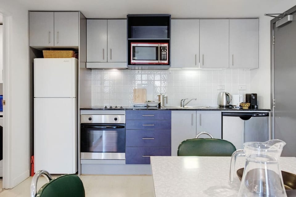 The kitchen is well-equipped for an apartment.