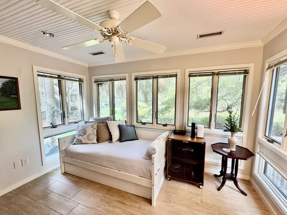 Sunroom overlooking lagoon; daybed and trundle sleeps 2. There is no door.