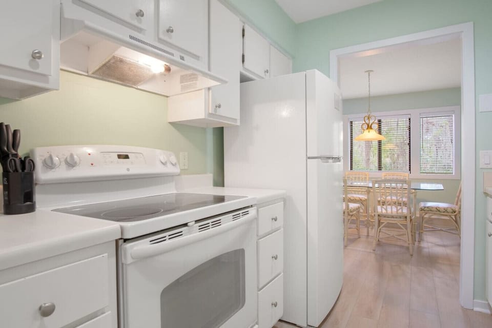 Fully equipped kitchen featuring updated appliances, new paint, and nearby laundry