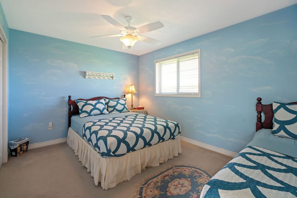 Lower level bedroom w/ queen + single Bed, closet, clean linens, window shades