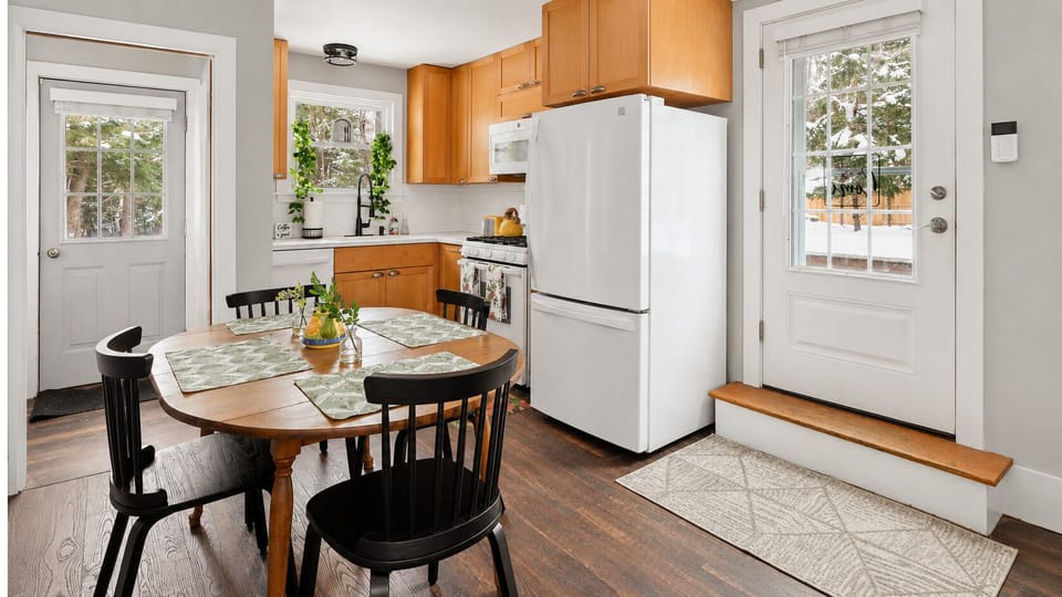 Eat-in kitchen with a fridge and easy access to the deck.