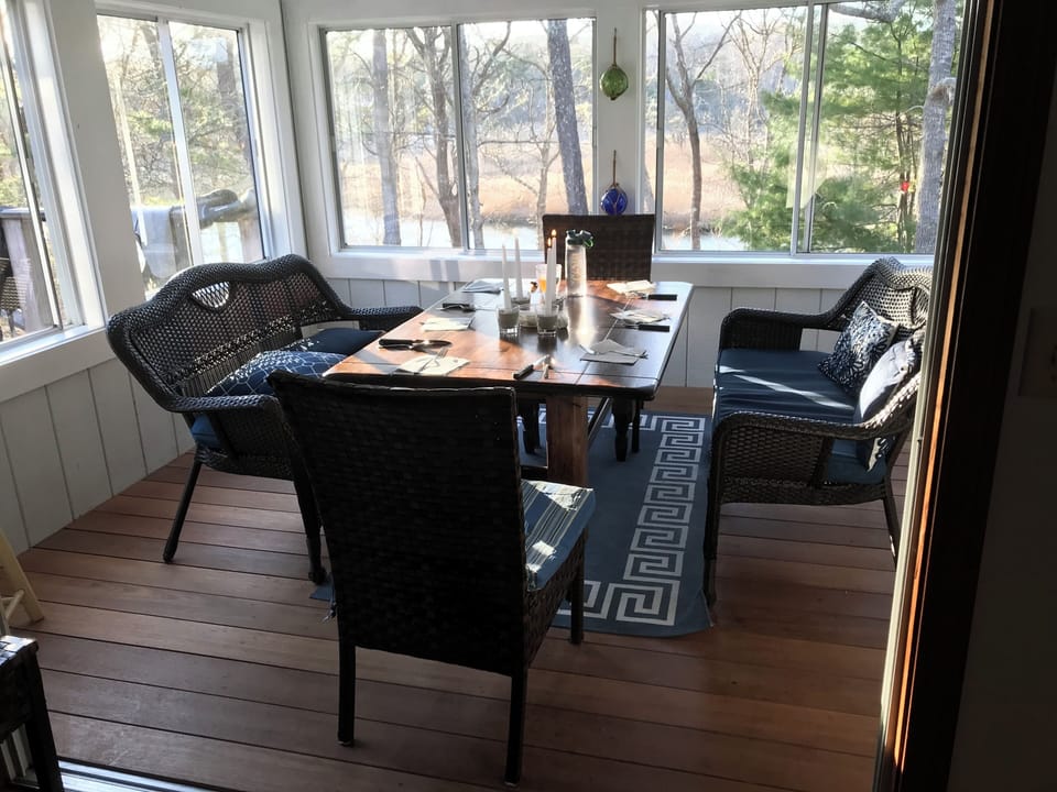 Enjoy your meals on this cozy screened in porch with private river views