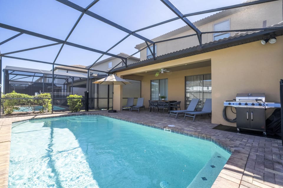 Sunlit screened patio with refreshing private pool and grill