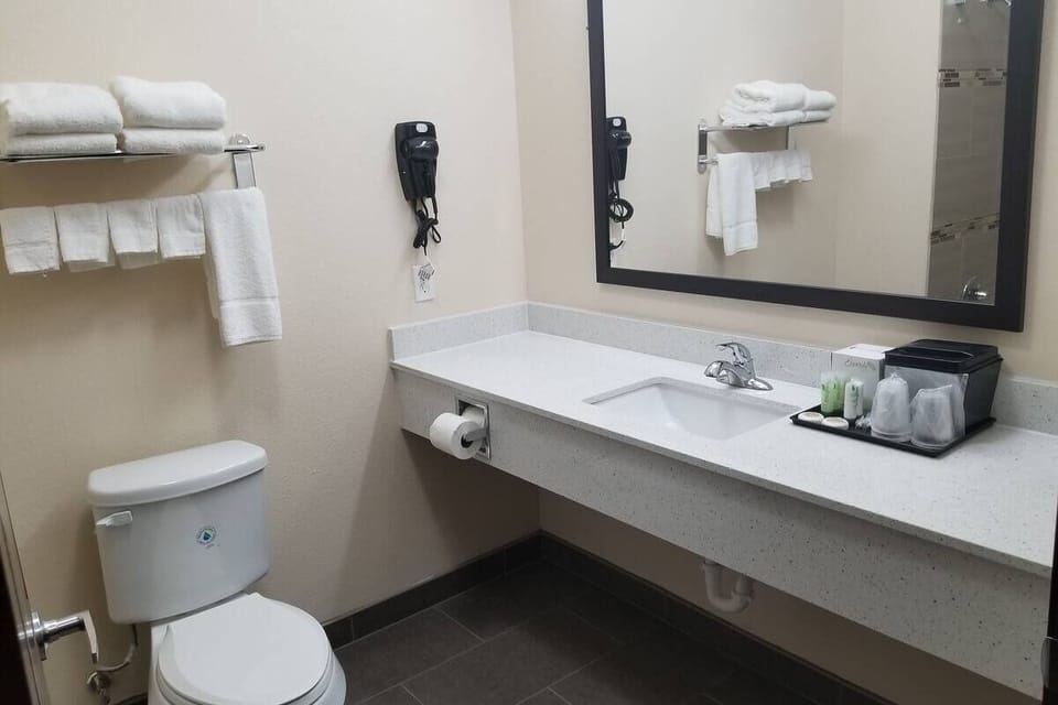 Refresh effortlessly with a bright vanity and plush towels.