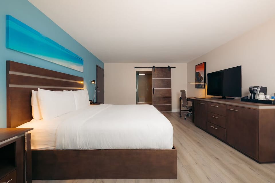 Unwind in a spacious room with TV, desk, and coffee.