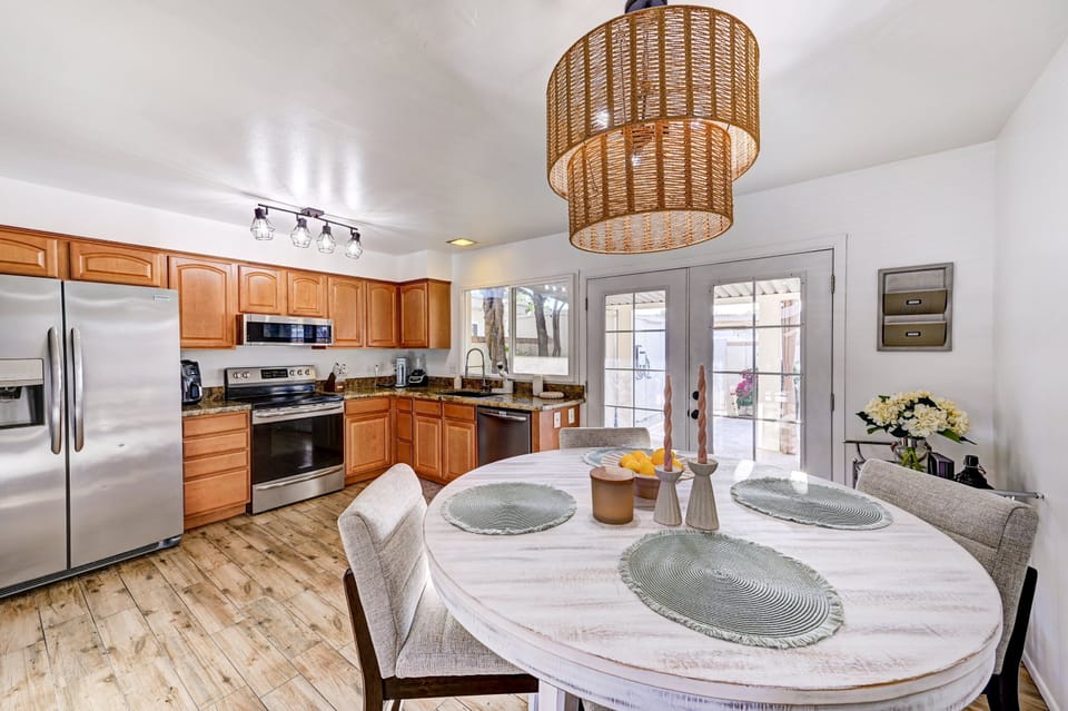 Gather around the table for breakfast or a sunset dinner. This fully equipped kitchen features stainless appliances and direct access to the private patio—perfect for dining in or out.